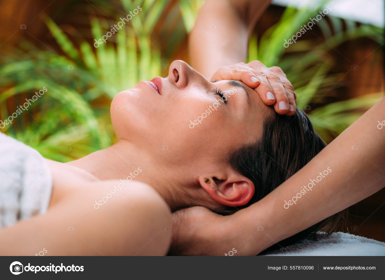 Craniosacral therapy massage. Therapist massaging woman’s forehead.